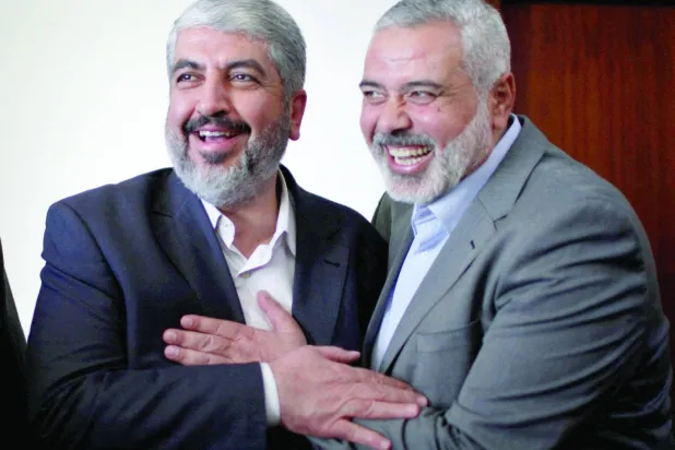 Khaled Meshaal (L) hugs Ismail Haniyeh before leaving the Gaza Strip. (Reuters file)