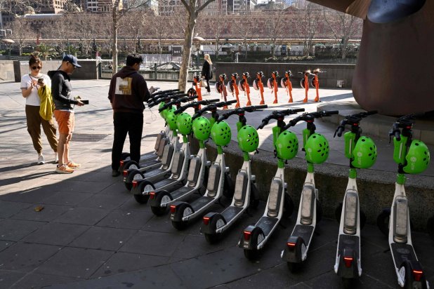 Hire e-scooters are lined up in Melbourne's central business district (CBD) on August 13, 2024. (Photo by William WEST / AFP)