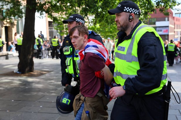 An anti-immigration protester is detained by police officers, in Newcastle, Britain August 10, 2024. REUTERS/Denis Balibouse