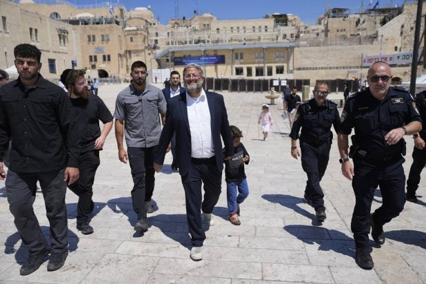 Israel's far-right National Security Minister Itamar Ben-Gvir, center, flanked by his security detail, approach the entrance to Jerusalem's most sensitive holy site, which Jews revere the site as the Temple Mount, believed to be the location of the First and Second Temples, and it is a holy site for Muslims as Haram al-Sharif or the Noble Sanctuary, in the Old City, Tuesday, Aug. 13, 2024. (AP) 