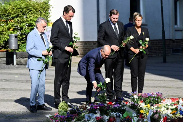 North Rhine-Westphalia state premier Hendrik Wuest, Solingen mayor Tim Kurzbach and German Chancellor Olaf Scholz pay their respects at the site where three people were killed and several injured in a stabbing attack at a festival, in Solingen, Germany. (Reuters/Jana Rodenbusch) 