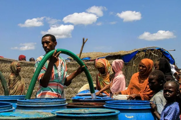  People collect clean water provided by a charity organization to people in Gedaref in eastern Sudan on August 30, 2024. (AFP)