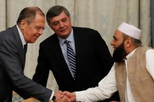 وزير الخارجية الروسي سيرغي لافروف يرحب بعضو وفد «طالبان» الحاج محمد سهيل شاينا خلال محادثات سابقة (إعلام أفغاني)