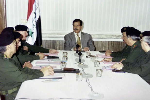 Saddam Hussein convenes with members of his regime in Iraq. (Getty Images) 
