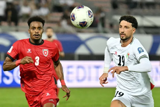 جانب من مواجهة فلسطين والأردن (أ.ف.ب)