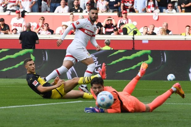 Stuttgart's German forward #26 Deniz Undav scores the opening goal past Dortmund's Swiss goalkeeper #01 Gregor Kobel during the German first division Bundesliga football match between VfB Stuttgart and Borussia Dortmund in Stuttgart on September 22, 2024. (AFP) 