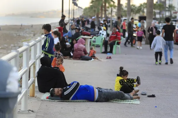  Lebanese citizens who fled on the southern villages amid ongoing Israeli airstrikes Monday, settle at a waterfront promenade in the southern port city of Sidon, Lebanon, Tuesday, Sept. 24, 2024. (AP)