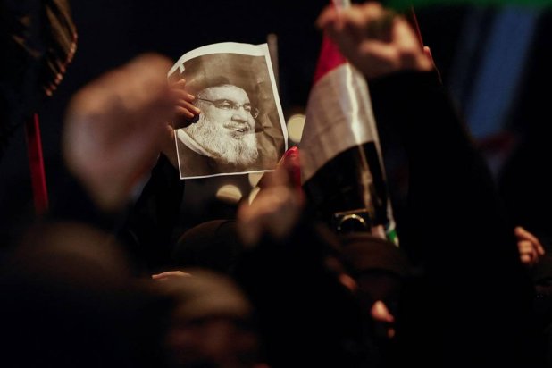 An Iraqi woman holds a picture of Lebanon's Hezbollah leader Hassan Nasrallah as she attends a protest following the announcement of his death, in Baghdad, Iraq, September 28, 2024. (Reuters) 