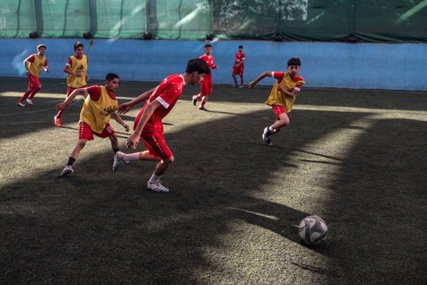 Afghan youths play futsal at a sports complex in Kabul on September 25, 2024. (AFP)