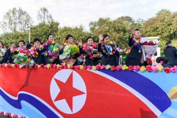 Members of North Korea's U-20 women's football team, wave at people from a vehicle upon their arrival in Pyongyang on September 28, 2024, after their victory against Japan at the 2024 FIFA U-20 Women's World Cup final football match, which took place at the Nemesio Camacho “El Campin” stadium in Colombia's capital Bogota. (AFP) 