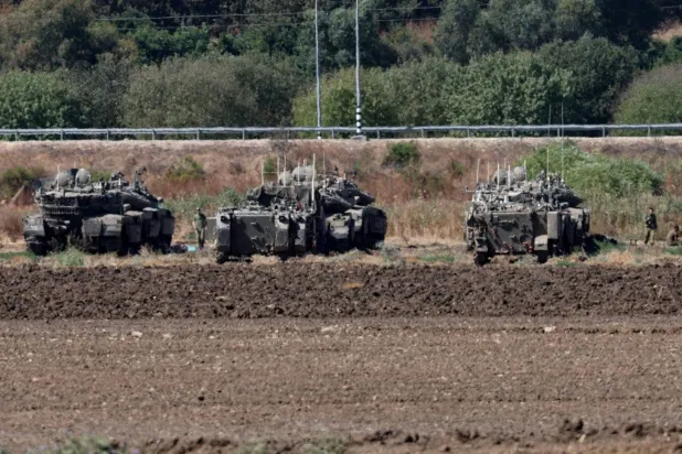Israeli armored vehicles prepare to enter Lebanon (EPA)