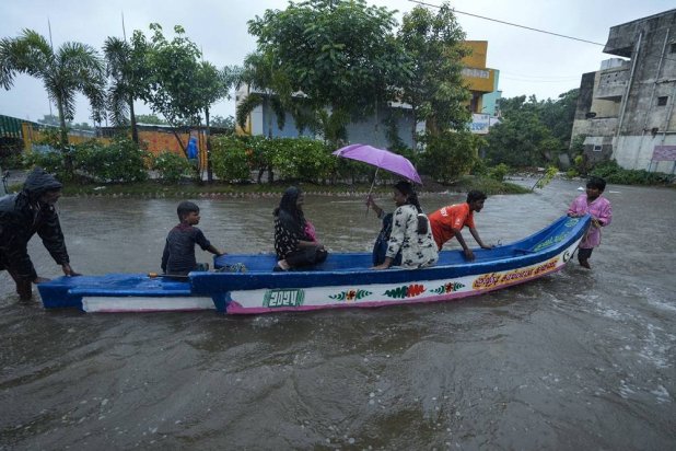  People use a boat on a flooded street to reach safer place during heavy rains in Chennai, India, Wednesday, Oct.16, 2024. (AP) 