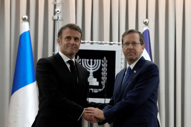 French President Emmanuel Macron, left, shakes hands with Israel's President Isaac Herzog in Jerusalem, Tuesday, Oct. 24, 2023. Emmanuel Macron is traveling to Israel to show France's solidarity with the country and further work on the release of hostages who are being held in Gaza. - Reuters