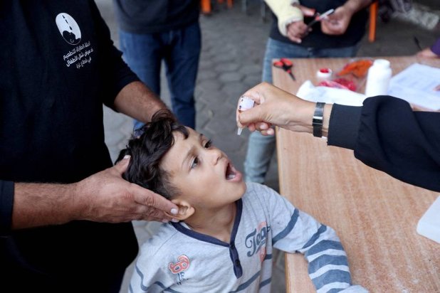 Palestinian child is vaccinated against polio during the second round of a vaccination campaign, amid the Israel-Hamas conflict, in Deir Al-Balah in the central Gaza Strip, October 14, 2024. (Reuters)
