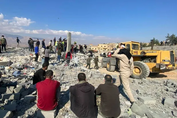 Rescuers and aid workers search for survivors at the site of an Israeli airstrike in eastern Lebanon (AFP)