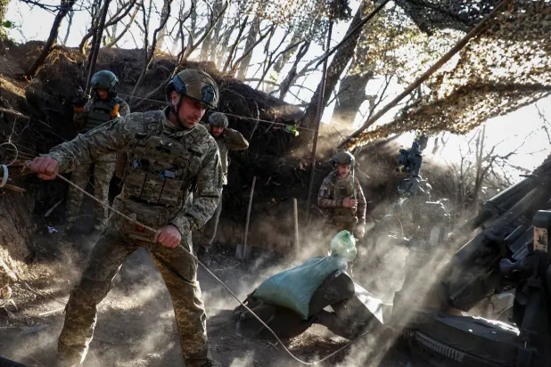 جنود أوكرانيون يطلقون قذيفة مدفعية باتجاه القوات الروسية على الجبهة قرب دونيتسك (رويترز)