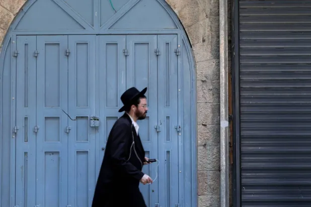 An Orthodox Jew walks in Old Jerusalem on November 5 (EPA)