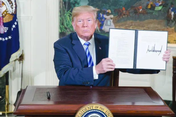 President Donald Trump shows a signed Presidential Memorandum after delivering a statement on the Iran nuclear deal from the Diplomatic Reception Room of the White House, Tuesday, May 8, 2018, in Washington. (AP)
