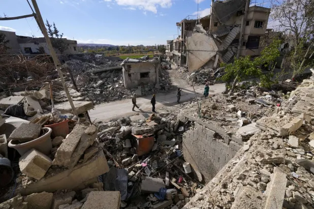 Residents check their destroyed neighborhood in Baalbek, eastern Lebanon, Thursday, Nov. 28, 2024. (AP Photo/Hassan Ammar)