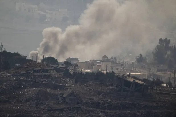  Smoke rise next to damaged buildings on an area of a village in southern Lebanon, as seen from the Kibbutz Manara, northern Israel, Thursday, Nov. 28, 2024. (AP)