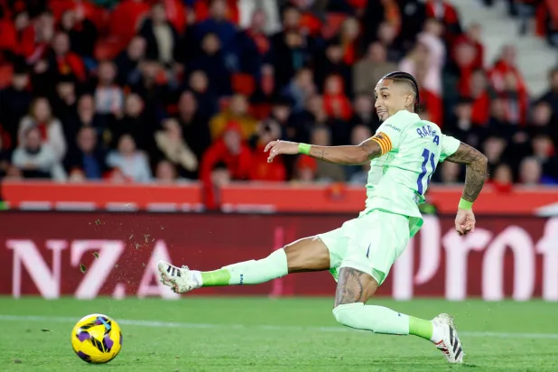 Barcelona's Brazilian forward #11 Raphinha kicks the ball during the Spanish league football match between RCD Mallorca and FC Barcelona at the Mallorca Son Moix stadium in Palma de Mallorca on December 3, 2024. (Photo by JAIME REINA / AFP)