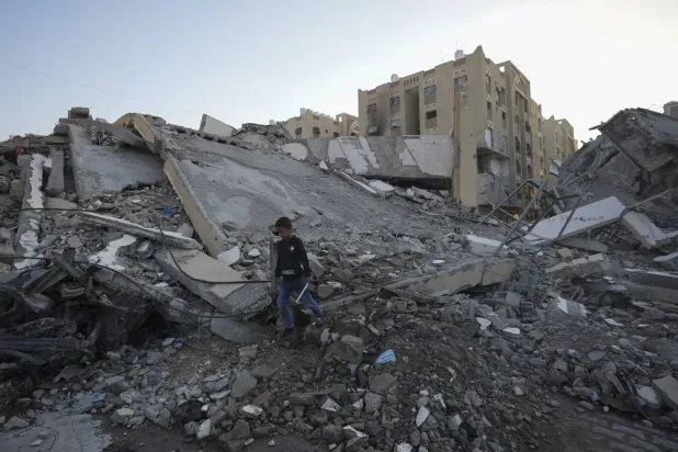  A Palestinian boy walks amongst rubble of destroyed buildings at a neighborhood in Khan Younis, Gaza Strip, Sunday, Dec. 1, 2024. (AP)