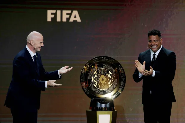 Soccer Football - Club World Cup - Draw - Miami, Florida, United States - December 5, 2024 FIFA president Gianni Infantino and Ronaldo unveil the trophy before the draw REUTERS/Brian Snyder 