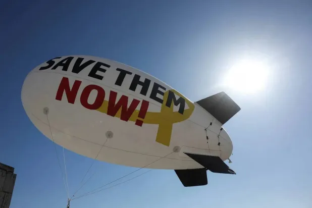 A blimp-shaped balloon launched by families and supporters of Israeli hostages held by Hamas in Gaza, flies over the prime minister's office, in Jerusalem, 02 December 2024. EPA/ABIR SULTAN