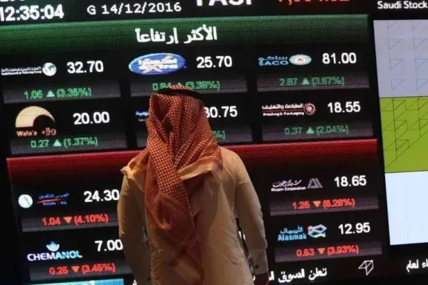 An investor stands in front of a screen displaying information from the Saudi Stock Exchange (Tadawul) in Riyadh (Reuters).