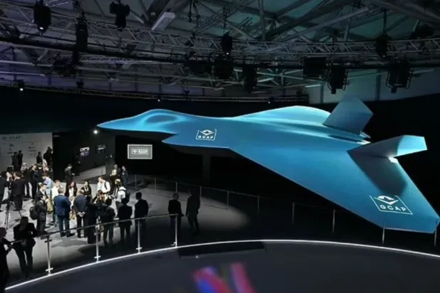 Delegates look at the Global Combat Air Program (GCAP) 6th generation fighter jet concept design at the Farnborough International Airshow 2024 - AFP


