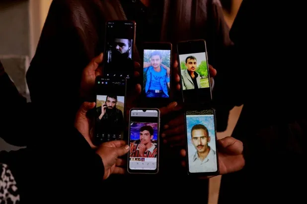 People display the photos of their relatives on mobile phones as they join members of the Syrian civil defense group, known as the White Helmets, in search of prisoners at the Sednaya prison, after the opposition seized the capital and announced that they have ousted President Bashar al-Assad, in Sednaya, Syria, December 11, 2024. (Reuters) 