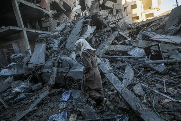 A Palestinian woman amid the rubble of her home in the Nusseirat camp in central Gaza after an Israeli airstrike. (EPA)