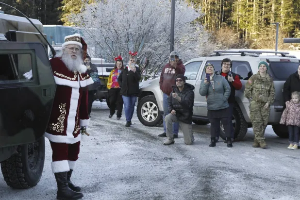 Santa Claus arrives at the school in Yakutat, Alaska,, as part of the Alaska National Guard's Operation Santa initiative that brings Christmas to an Indigenous community that has suffered a hardship, Wednesday, Dec. 18, 2024. (AP Photo/Mark Thiessen). 