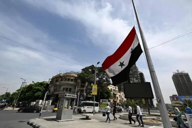 The Syrian flag is flown at half-mast in Damascus on May 20, 2024 (AFP)