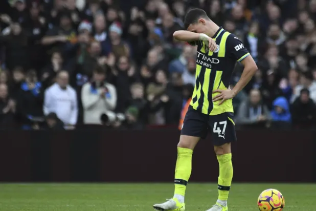 Manchester City's Phil Foden reacts after Aston Villa's Morgan Rogers scoring his side's second goal during the English Premier League soccer match between Aston Villa and Manchester City, at Villa Park in Birmingham, England, Saturday, Dec. 21, 2024. (AP Photo/Rui Vieira)