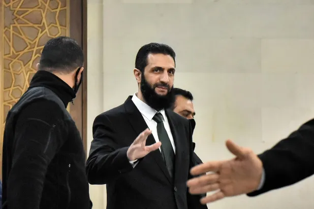 Syria's new leader Ahmed al-Sharaa (C) arrives for a meeing with visiting Druze officials from Lebanon's Progressive Socialist Party (PSP) in Damascus on December 22, 2024. (Photo by AFP)
