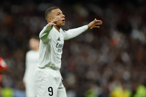 Real Madrid's French forward #09 Kylian Mbappe reacts during the Spanish league football match between Real Madrid CF and Sevilla FC at the Santiago Bernabeu stadium in Madrid on December 22, 2024. (Photo by OSCAR DEL POZO / AFP)
