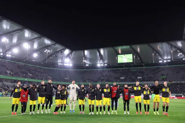 Borussia Dortmund's players celebrate with the fans after the German first division Bundesliga football match between VfL Wolfsburg and Borussia Dortmund in Wolfsburg on December 22, 2024. (Photo by Ronny HARTMANN / AFP)