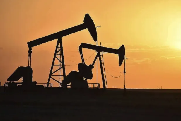 FILE - Pump jacks extract oil from beneath the ground in North Dakota, May 19, 2021. (AP Photo/Matthew Brown, File)
