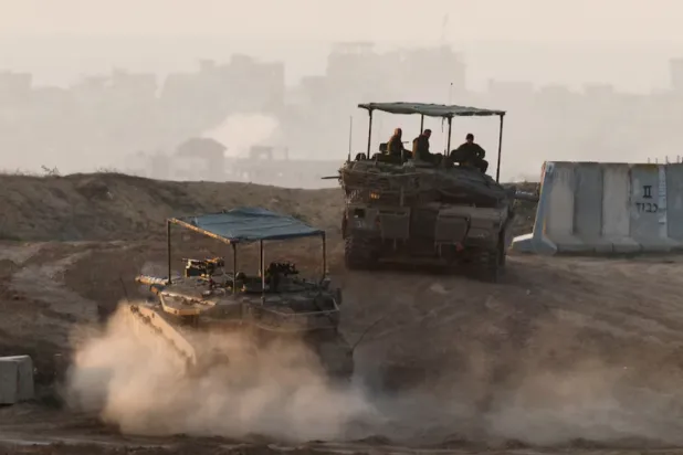 Israeli tanks take a position, amid the ongoing conflict in Gaza between Israel and Hamas, near the Israel-Gaza border, as seen from Israel, December 22, 2024. REUTERS/Amir Cohen 