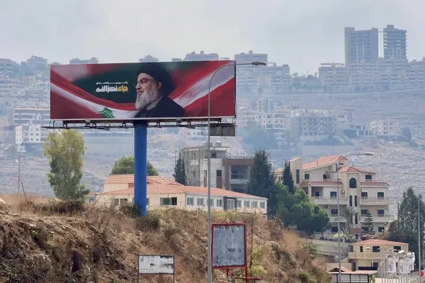 An image of slain Hezbollah Secretary General Hassan Nasrallah is seen on a billboard on the Beirut-South highway. (EPA) 