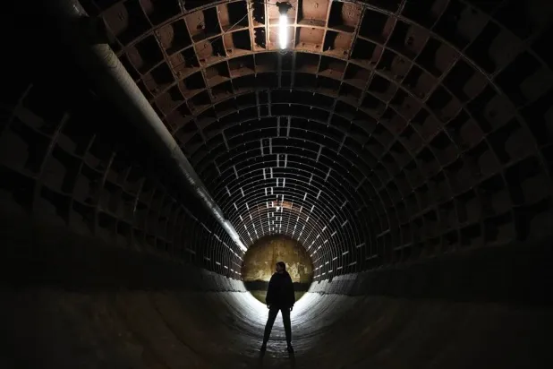 A woman takes a tour of the Bunker-703, a recently declassified nuclear-resistant bomb shelter built in 1961 at a depth of 43 meters (141 feet) for the Soviet Foreign Affairs Ministry archive, in Moscow, Russia, Sunday, Dec. 22, 2024. (AP) 