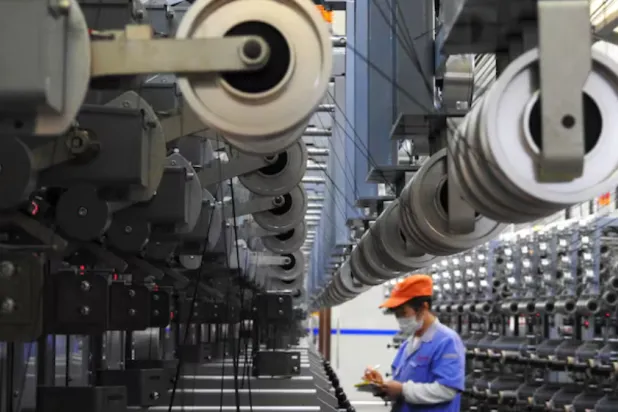 An employee works at a carbon fibre production line inside a factory in Lianyungang, Jiangsu province, China October 27, 2018. REUTERS/Stringer 