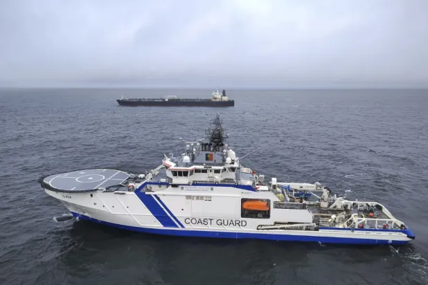 This photo provided by Rajavartiosto (Finnish Border Guard) on Thursday, Dec. 26, 2024, shows the oil tanker Eagle S, background, and the Finnish der Guard ship Turva at sea outside Porkkalanniemi, Finland. The Eagle S was sailing at the same time in the area where the Finland-Estonia electrical link was disrupted on Wednesday (Rajavartiosto via AP)