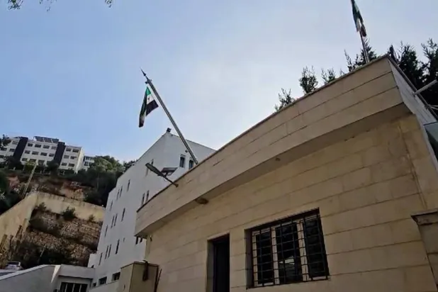 The Syrian revolution flag is raised over the Syrian embassy in Lebanon. (SANA)