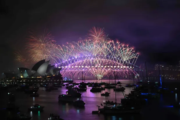 Fireworks light up the midnight sky over Sydney Harbour Bridge and Sydney Opera House during 2025 New Year Day celebrations in Sydney on January 1, 2025. (Photo by Saeed KHAN / AFP)