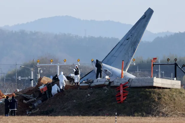 Officials take part in an investigation at the site where a Jeju Air Boeing 737-800 aircraft crashed and burst into flames at Muan International Airport in Muan, some 288 kilometres southwest of Seoul on January 1, 2025. (Photo by YONHAP / AFP)