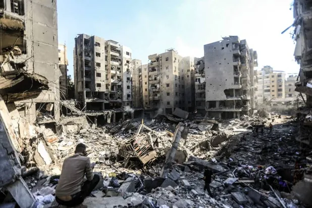 People look through the rubble of buildings which were leveled on September 27 by Israeli strikes that targeted and killed Hezbollah leader Hassan Nasrallah, in the Haret Hreik neighborhood of Beirut's southern suburbs, on September 29, 2024. (AFP)