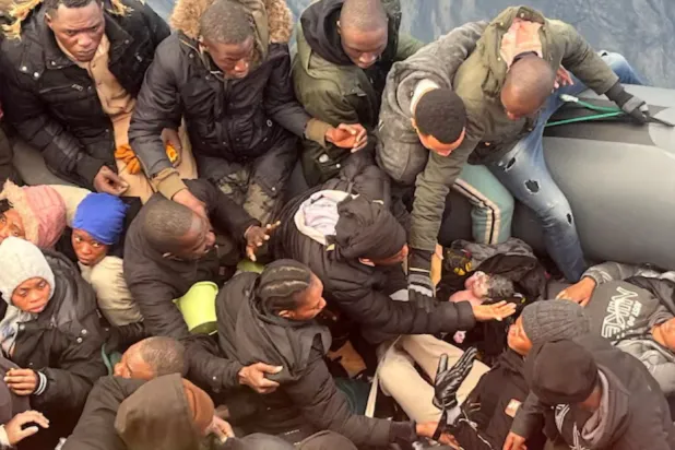 A migrant holds a newborn baby as a woman lies inside a rubber boat with other migrants who were rescued off the island off the Canary Island of Lanzarote in Spain, in this handout picture obtained on January 8, 2025/File Photo 