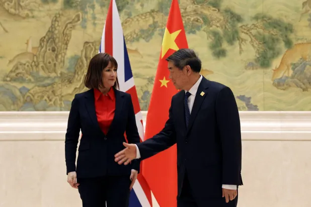 نائب رئيس الوزراء الصيني يصافح ريفز قبل قمة الخدمات المالية في دار ضيافة الدولة في بكين (رويترز)